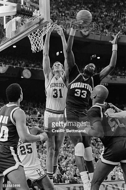 Georgetown Hoyas 7' Patrick Ewing and Kentucky Wildcats 7'1" center Sam Bowie battle for a rebound during the Georgetown 53-40 victory in semi-final...