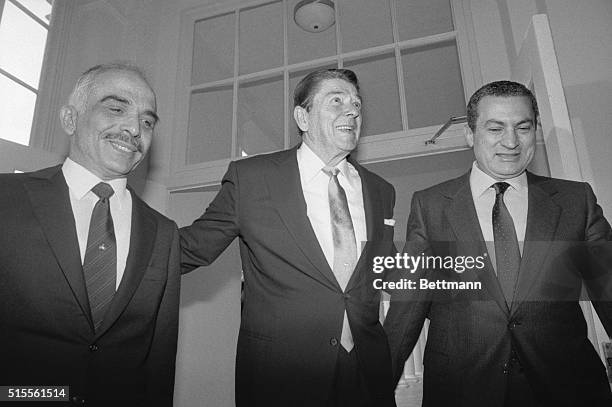 Washington, D.C.: President Reagan escorts King Hussein of Jordan and President Hosni Mubarak of Egypt into the White House main residence for a...