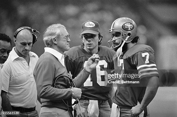 San Francisco 49ers' coach Bill Walsh is shown talking to his quarterbacks, Joe Montana and Guy Benjamin, during a game against the New Orleans...
