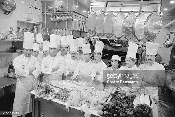 Paul Bocuse, the best known chef in France, poses with his kitchen crew and a table piled high with chickens and live lobsters. Although he no longer...