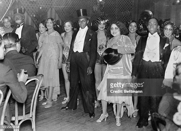 Harlem, New York City: Picture shows men and women entertainers at Small's Paradise Clubin Harlem. Photo shows man in tuxedo and top hat in center.