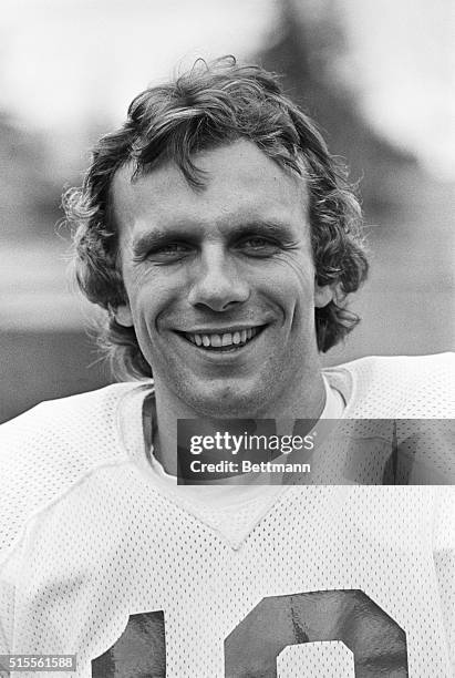 San Francisco 49ers quarterback Joe Montana is shown in a close-up, smiling. In this particular frame, the top of the numbers on his jersey are...