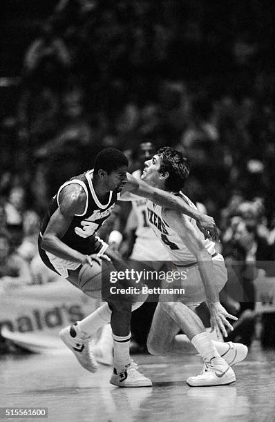 Los Angeles Lakers Magic Johnson uses his arm to keep Sixer's Bobby Jones away from the ball, as he drives towards the basket in fourth quarter...