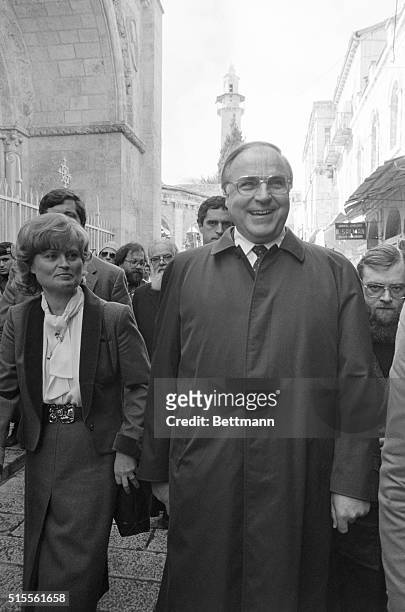 Jerusalem: West German chancellor Helmut Kohl and his wife, Hannelore, walk down a street in Jerusalem's Old City on their way to the Russian church...