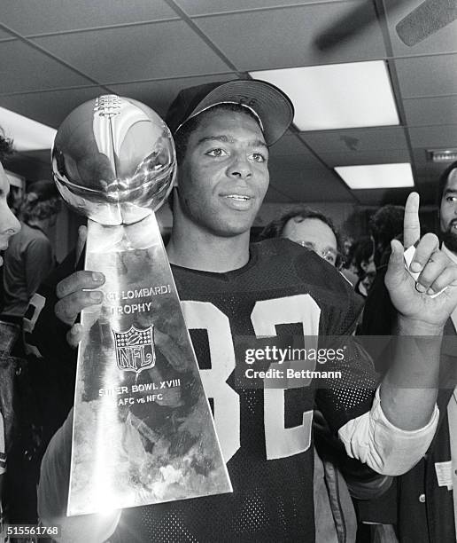 Tampa: Raiders running back Marcus Allen holds the Vince Lombardi trophy and indicates L.A. Is number one. The Raiders defeated the Redskins in Super...