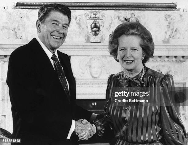 London, England- Prime Minister, Margaret Thatcher, is shown greating President Reagan to No. 10 Downing Street.