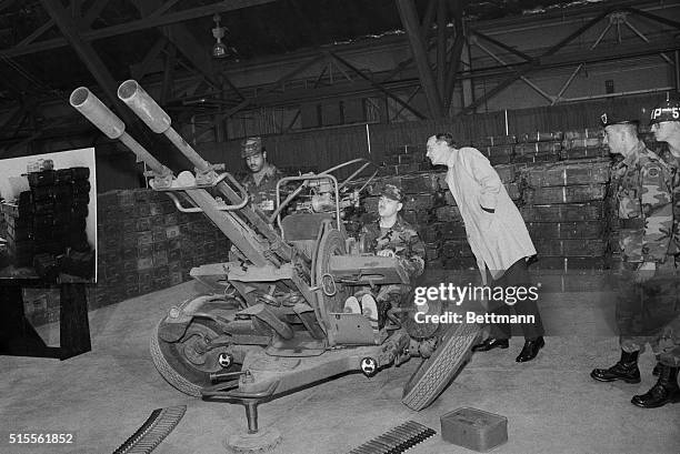 Washington, D.C.: Vice President George Bush looks at a Soviet made ZU-23mm anti-anticraft gun at Andrews Air Force Base. The anti-aircraft gun. ....