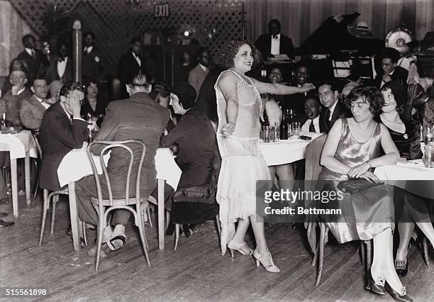 Harlem, New York City: Picture shows "The Entertainer," at Small's Paradise Club in Harlem. A woman is shown dancing while men and women seated at...