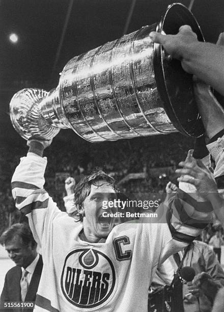 Edmonton Oilers team captain Wayne Gretzky lifts the Stanley Cup high over his head after the Oilers beat the New York Islanders, 5-2, to win the...