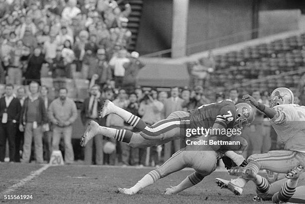 San Francisco 49ers' Fred Dean, , sacks Detroit Lions' QB Gary Danielson for an 8 yard loss with one minute eighteen seconds left on the clock in the...