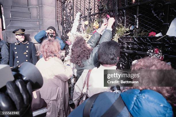 New York: Distraught fans of ex-Beatle John Lennon gather outside his apartment building , late December 8, after he was gunned down by a man...