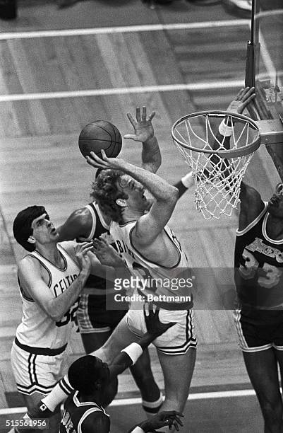 Larry Bird of the Boston Celtics' is pushed from behind as he goes up for the basket as the Lakers' Kareem Abdul Jabbar tries to stop him. Pushing...
