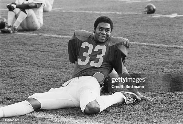 December 16, 1981 - Los Angeles: Marcus Allen, USC tailback, stretches on the practice field at USC after being named 1981 UPI Player of the Year and...