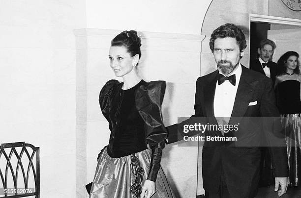 Ever lovely actress Audrey Hepburn and her escort, actor Robert Wolders are shown at the White House for a reception at which the President was to...