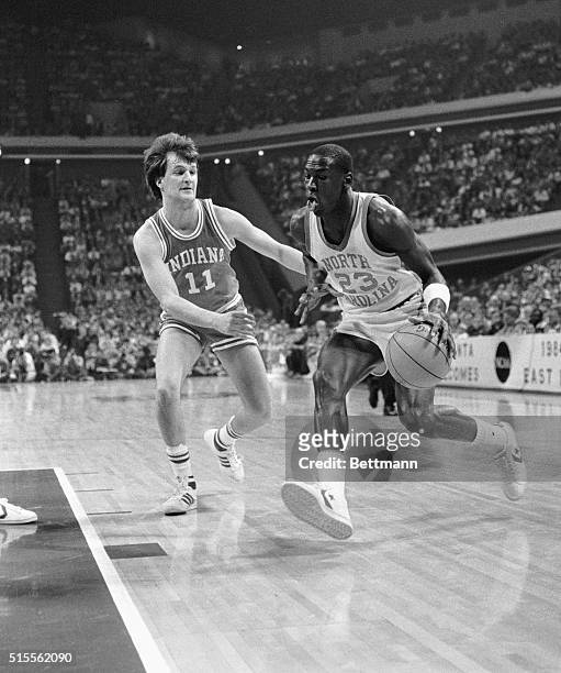 Michael Jordan of North Carolina drives to the basket during first half action 3/22 as Dan Dakich of Indiana attempts to cover him.
