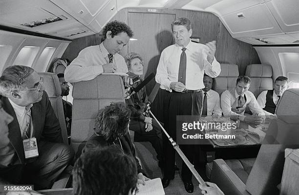 Fairbanks, Alaska: president Reagan talks with members of the press aboard Air Force One en route form Shanghai to Alaska 5/1, as Nancy looks on.