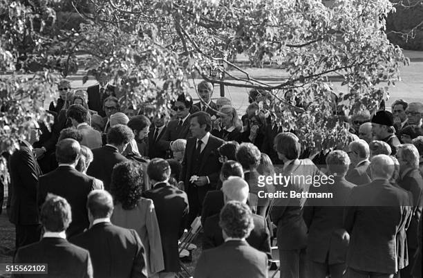 Hollywood: Actor Robert Wagner stands amid friends holding a flower from his wife's casket at graveside ceremonies for actress Natalie Wood who...