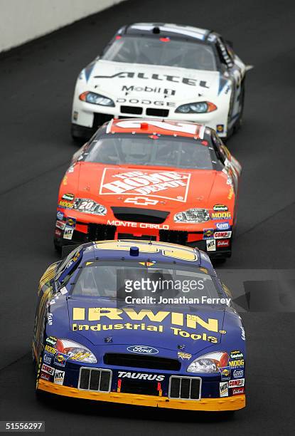 Kurt Busch driving his Irwin Ford leads Tony Stewart in his Home Depot Chevrolet and Ryan Newman in his Alltell Dodge during the NASCAR Nextel Cup...