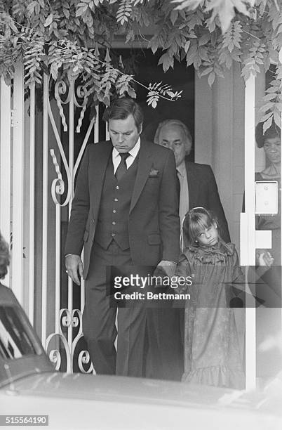 Actor Robert Wagner leads his daughter, Courtney, age 6, as they leave their Beverly Hills home on the way to funeral services for Wagner's wife,...