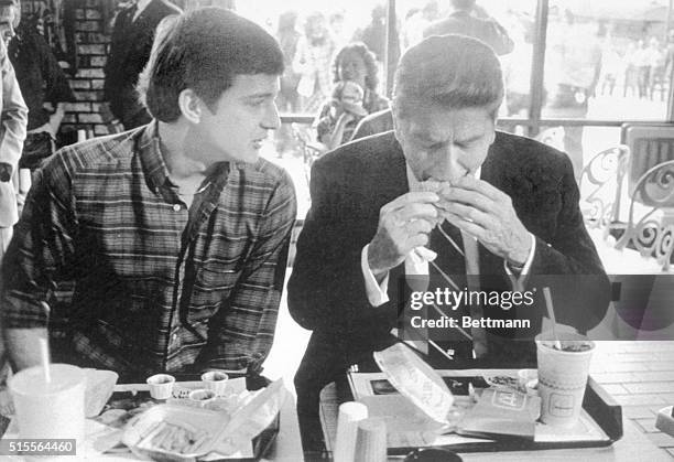 Tuscaloosa, Alabama: President Reagan bites into a Big Mac and has french fries and a soft drink waiting. President Reagan lunched at a McDonalds...