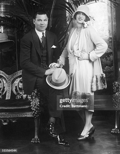 Here are handsome Jack Dempsey and charming Estelle Taylor, his bride, pictured at Reville's salons, Hanover Square, where Dempsey's bride selected a...