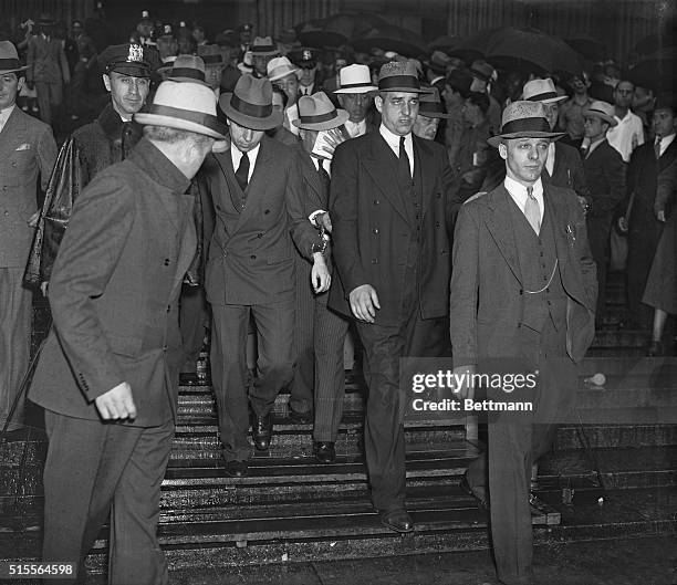 Charles "Lucky" Luciano, convicted as dictator of organized vice in New York City, shown second from left with his head slightly lowered, as he...