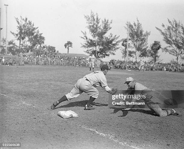 John Mize, St. Louis Cardinal infielder, out at 1st base, caught napping by catcher Joe Glenn after taking a liong lead off the bag, during the game...
