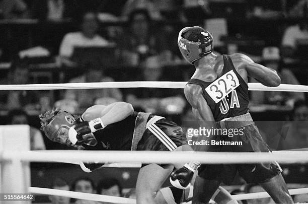 S Evander Holyfield knocks New Zealand's Kevin Barry in the first round of their fight at the 1984 Olympic in Los Angeles 8/9, in the second round he...