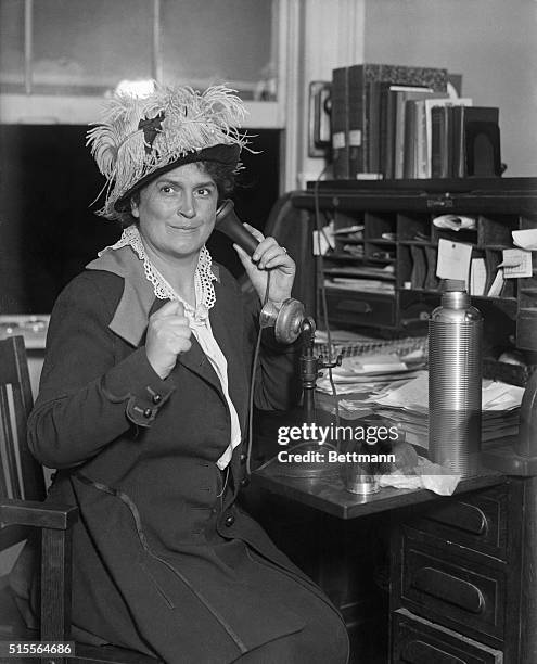 Mrs. Harriet Laidlow, leader in the suffrage movement, sitting at her desk, using the telephone.