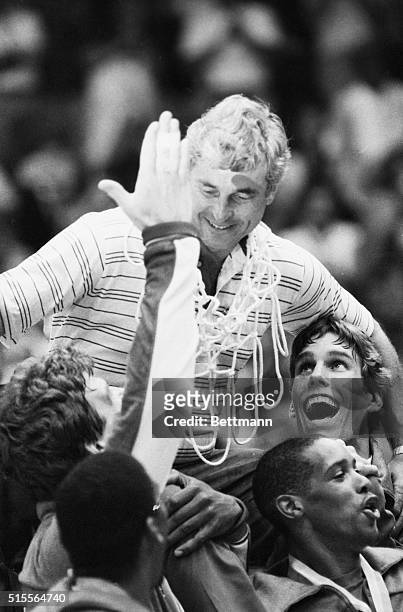 Los Angeles, California: USA basketball coach, Bobby Knight, is carried by his players after gold medal victory over Spain in the Olympic final,...