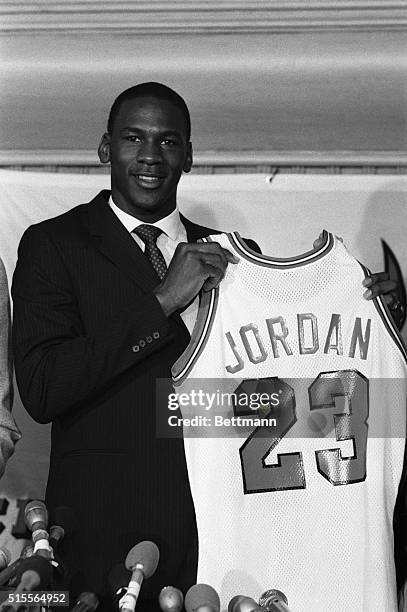 Former North Carolina star, College Player of the Year and star of the US Olympic gold medal winning basketball team, Michael Jordan holds up his...