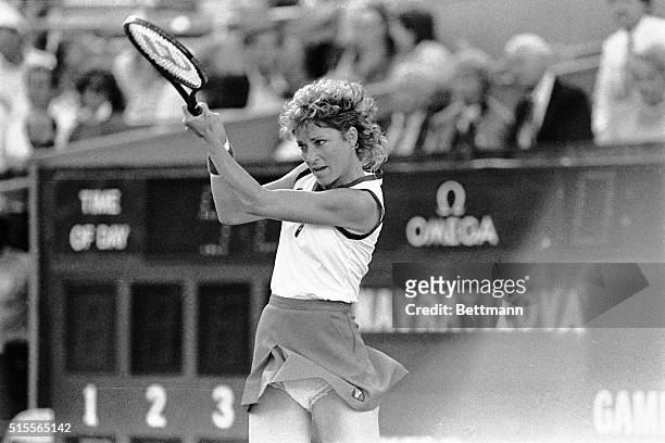Second seeded Chris Evert Lloyd hits a two fisted backhand during her women's final match with Martina Navratilova 9/8. Photo shows Chris holding...