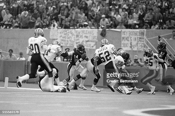 Chicago Bears' Walter Payton weaves through the New Orleans Saints' Gary Russell , Paul Whitney and Jim Kovach to pick up the final yardage to beat...