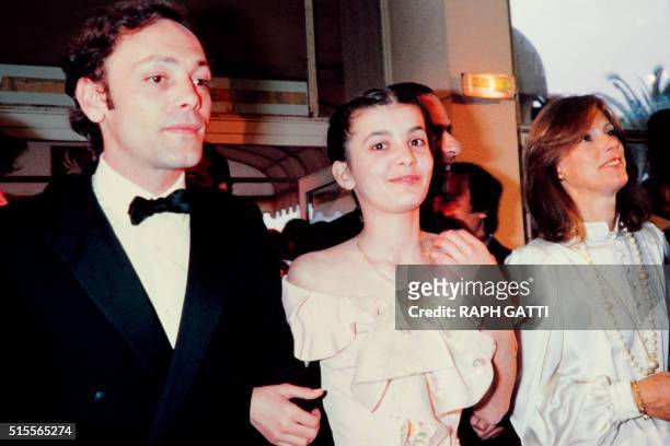 French actor Patrick Dewaere, actress Ariel Besse and wife of director Bertrand Blier arrive for the screening of the film "Bau-père" on May 21, 1981...