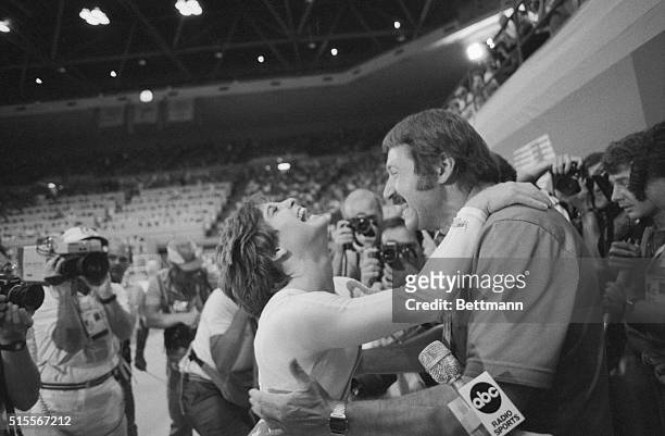 Los Angeles: Olympic gymnast Mary Lou Retton scores a perfect 10 in the vault to win the gold medal, then runs over and hugs her coach Bela Karoly....