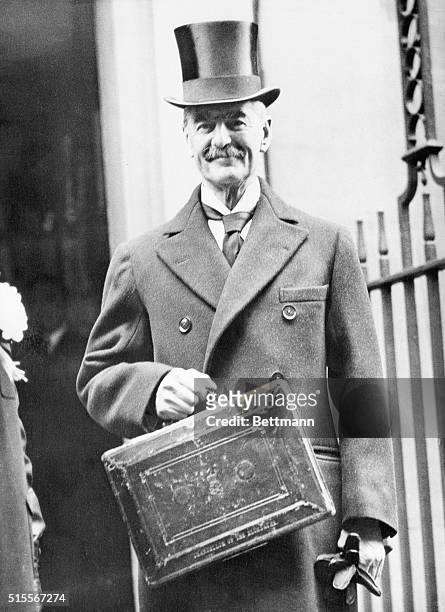 London, England- Neville Chamberlain, the British Chancellor of the Exchequer, smiling as he left No. 10 Downing Street for the House of Commons to...