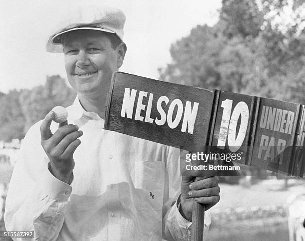 Nelson Takes Tam O'Shanter Open. Chicago, Illinois, USA: Byron Nelson of Toledo, Ohio, is gleeful as he displays his ball and the scoreboard which...