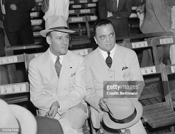 Edgar Hoover, Chief G-Man and his right-hand man, Clyde Tolson, snapped at ringside as they attended the Louis-Sharkey fight, at the Yankee Stadium...