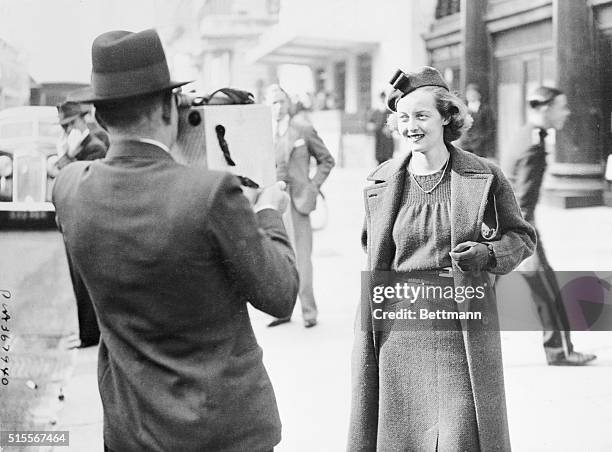 Bette Davis, popular film star, has her picture taken as she left her hotel in London for court where she sought to have her contract with Warner...