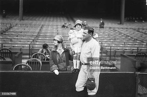 New York: Babe Ruth with wife and baby daughter, Dorothy whom he is kissing before game at the Yankee Stadium.