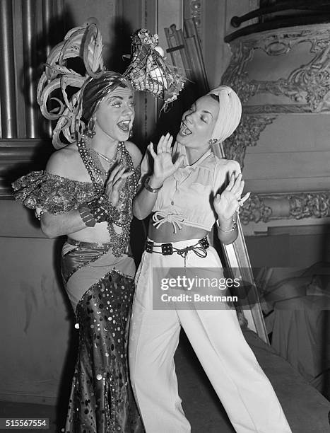 The irrepressible Mickey Rooney , now filming MGM's Babes of Broadway, does a Carmen Miranda impersonation for the real Carmen , who paid Mickey a...