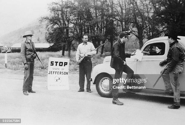 Leaders of a "secession" movement halt an automobile on the main highway here to put a "Proclamation of Independence" into the hands of the motorist....
