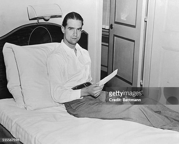 Millionaire movie producer and aviator Howard Hughes resting after breaking coast to coast record.