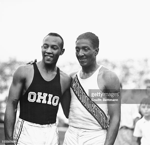 Jesse Owens of Ohio State , and Ralph Metcalfe of the Marquette Club, after they had finished in one-two order, respectively, in the 100 meter event...