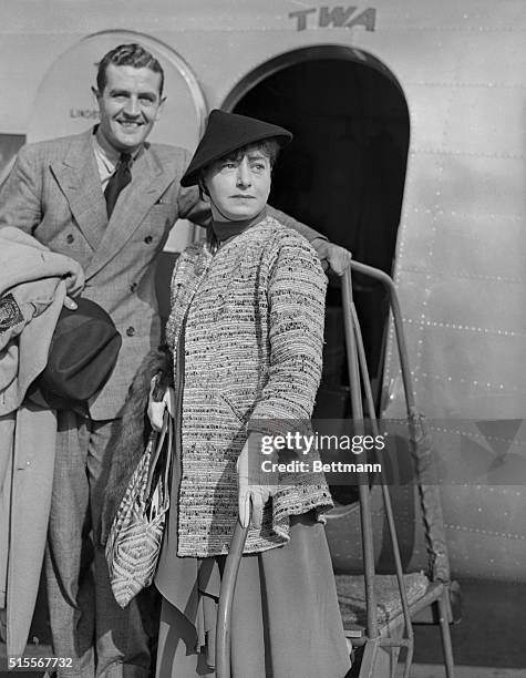 Arriving in Hollywood for more film writing and more wisecracks to panic film dinner parties, Dorothy Parker is shown with her husband, Alan Cambell,...