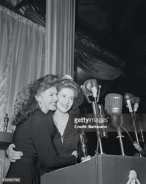 Ginger Rogers presents Joan Fontaine with the bronze statuette awarded to her by the Academy of Motion Picture Arts and Sciences for her role in...