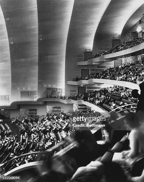 New York: Radio City Raises Curtain--On World's Largest Theater. The tiered auditorium gives this modernistic aspect to the Radio City Music Hall...