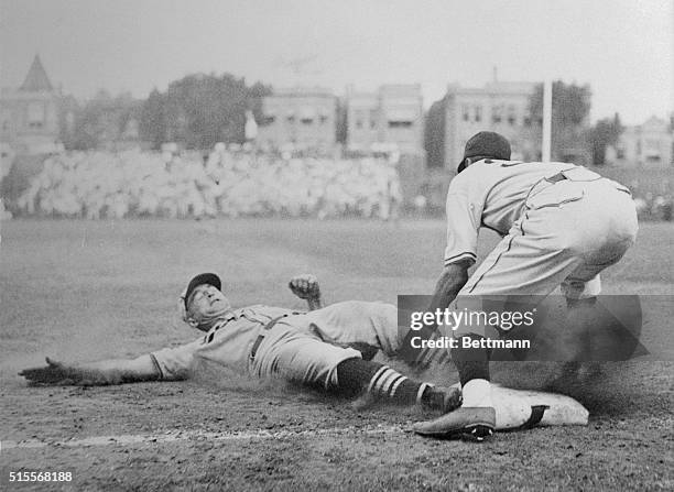 Manager Frankie Frisch sliding safely into third base in game with Chicago Cubs. He scored on Mize's homer which won the game for the Cardinals and...