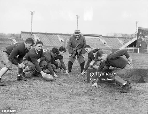 Glenn S. "Pop" Warner gets into action as new head coach of Temple University by putting these members of the football squad through some rigorous...