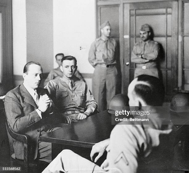 Heinrich Heinck, under heavy guard, awaits the convening of the special seven-man commission for the third day's proceedings of the trial of eight...